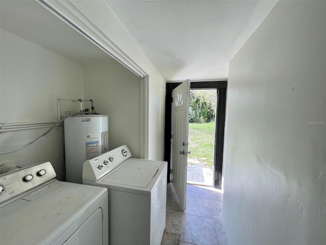 laundry room with electric water heater, independent washer and dryer, a textured ceiling, and light tile patterned flooring