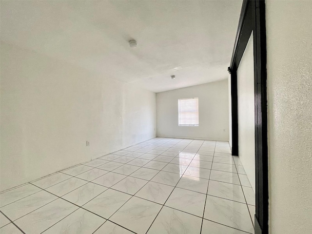 unfurnished room featuring light tile patterned flooring