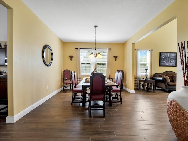 dining area featuring dark hardwood / wood-style floors and a notable chandelier