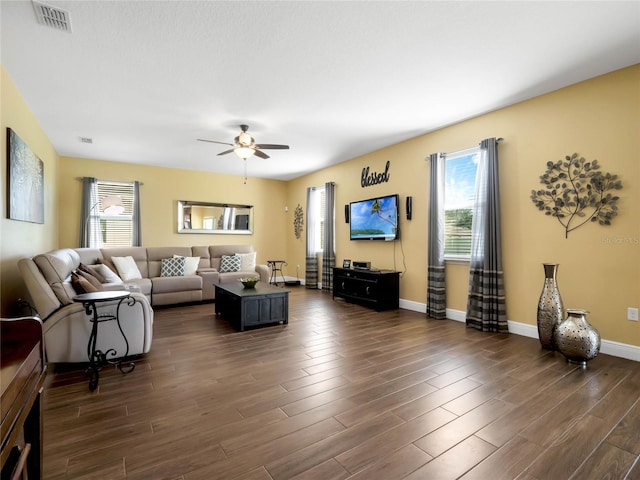 living room featuring ceiling fan and dark hardwood / wood-style floors