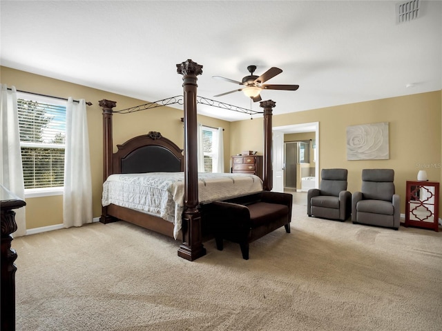 bedroom featuring connected bathroom, light carpet, and ceiling fan