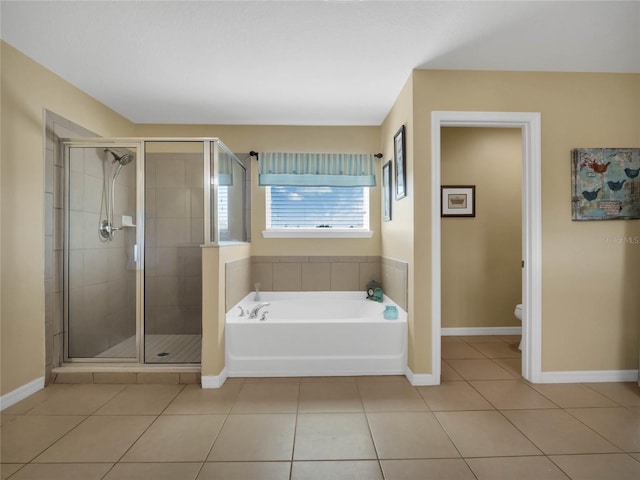 bathroom featuring shower with separate bathtub, tile patterned floors, and toilet