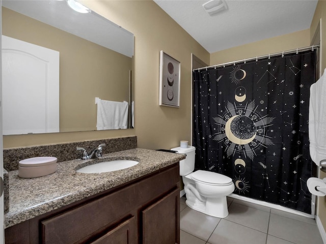 bathroom featuring tile patterned floors, toilet, and vanity