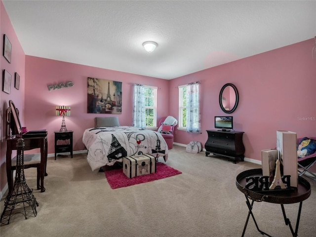 bedroom with carpet and a textured ceiling