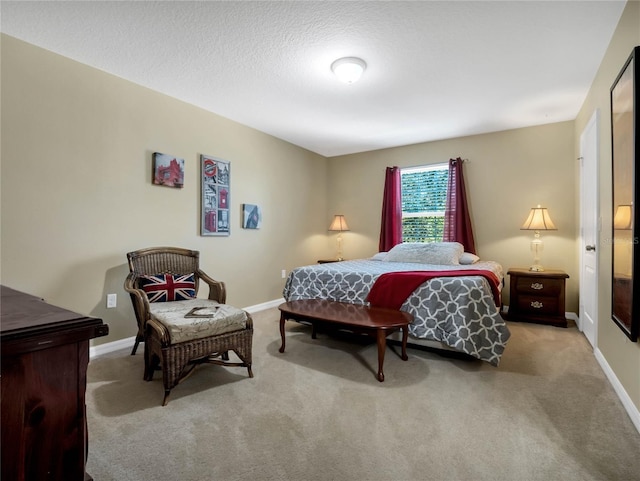 bedroom featuring light carpet and a textured ceiling