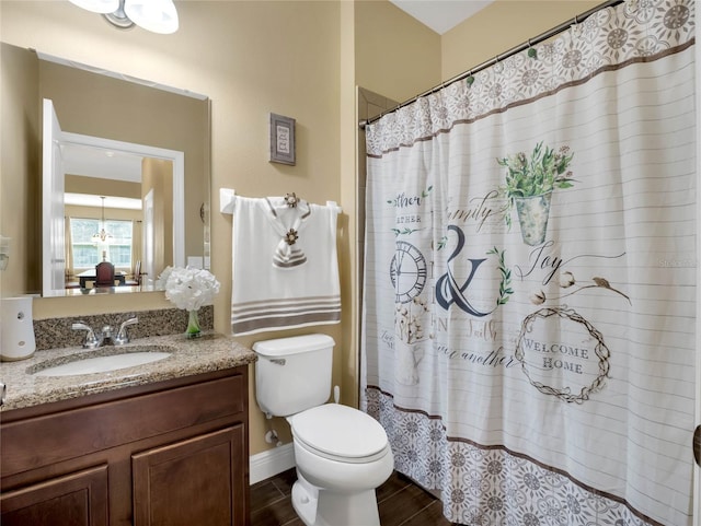 bathroom with vanity, curtained shower, and toilet