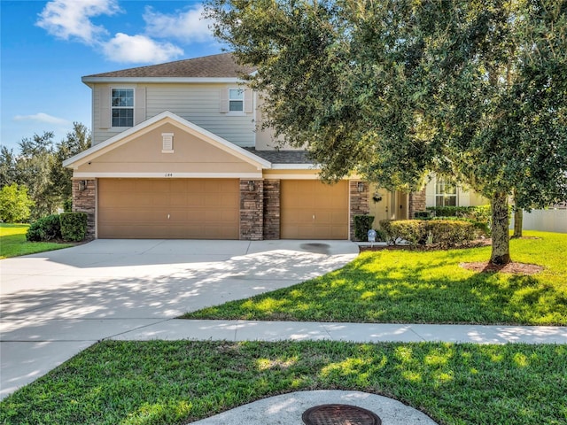 view of front of home featuring a garage and a front yard