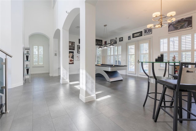 dining room featuring a high ceiling and crown molding