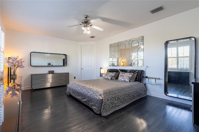 bedroom with dark hardwood / wood-style floors and ceiling fan