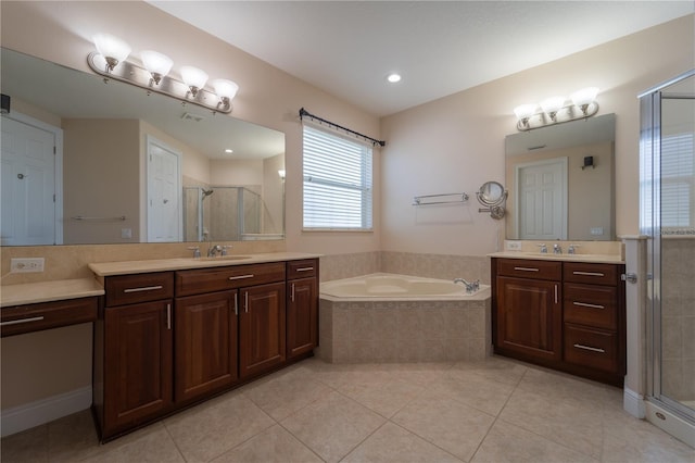 bathroom with vanity, tile patterned floors, and shower with separate bathtub