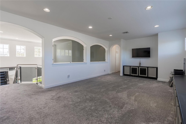 unfurnished living room with dark carpet