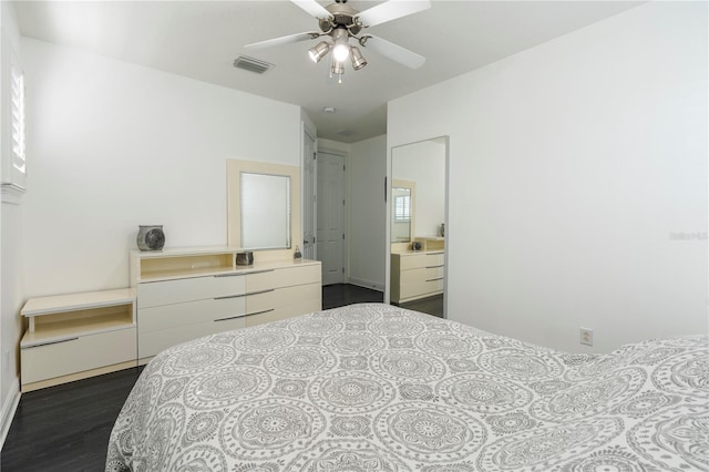 bedroom with dark hardwood / wood-style flooring