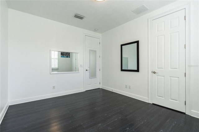 unfurnished room featuring dark hardwood / wood-style floors