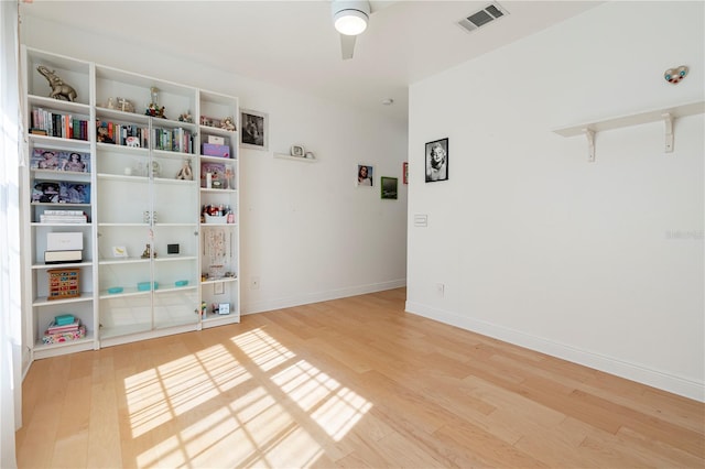 spare room with hardwood / wood-style floors and ceiling fan