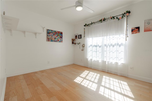 empty room featuring ceiling fan and light wood-type flooring