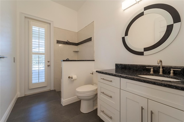 bathroom with walk in shower, vanity, and toilet