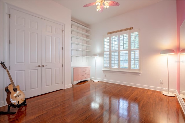 unfurnished bedroom with hardwood / wood-style floors, ceiling fan, and a closet