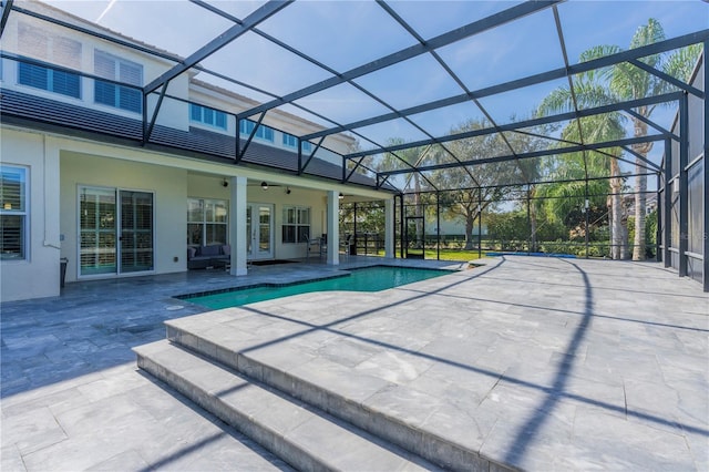 view of pool featuring a lanai, a patio, and ceiling fan