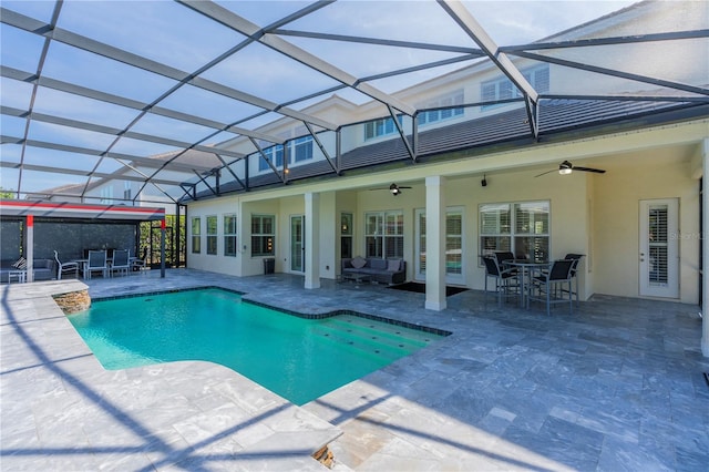 view of pool featuring a lanai, a patio area, and ceiling fan