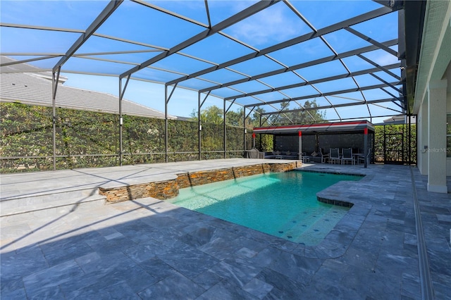 view of swimming pool with pool water feature, glass enclosure, and a patio area