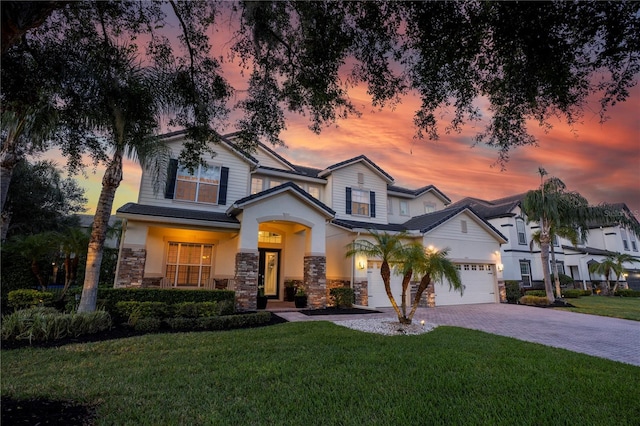 1910 Lake Roberts Landing Dr, Winter Garden, FL 34787 - view of front of property with stone siding, a front yard, decorative driveway, and an attached garage