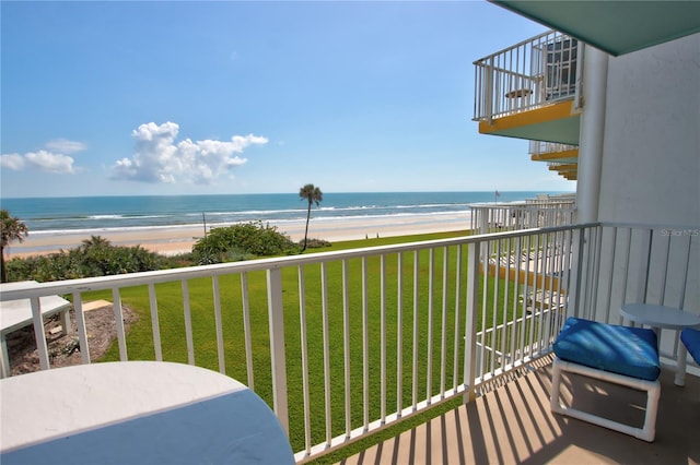 balcony with a water view and a beach view