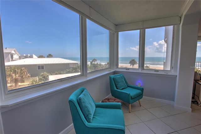 sunroom / solarium with a healthy amount of sunlight and a water view