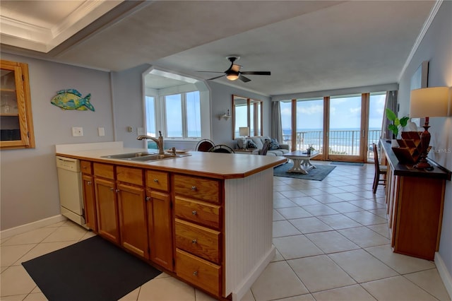 kitchen featuring white dishwasher, sink, crown molding, and light tile patterned flooring