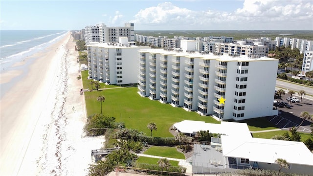 aerial view with a water view and a beach view