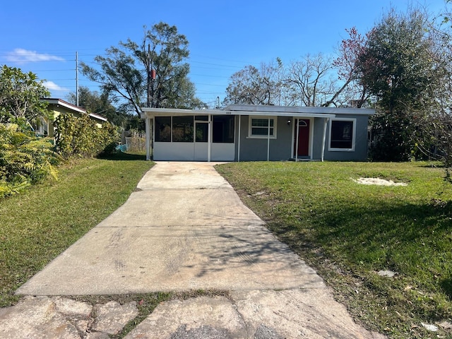 1315 Carlsbad Pl, Orlando, FL 32808 - ranch-style home featuring a sunroom and a front lawn