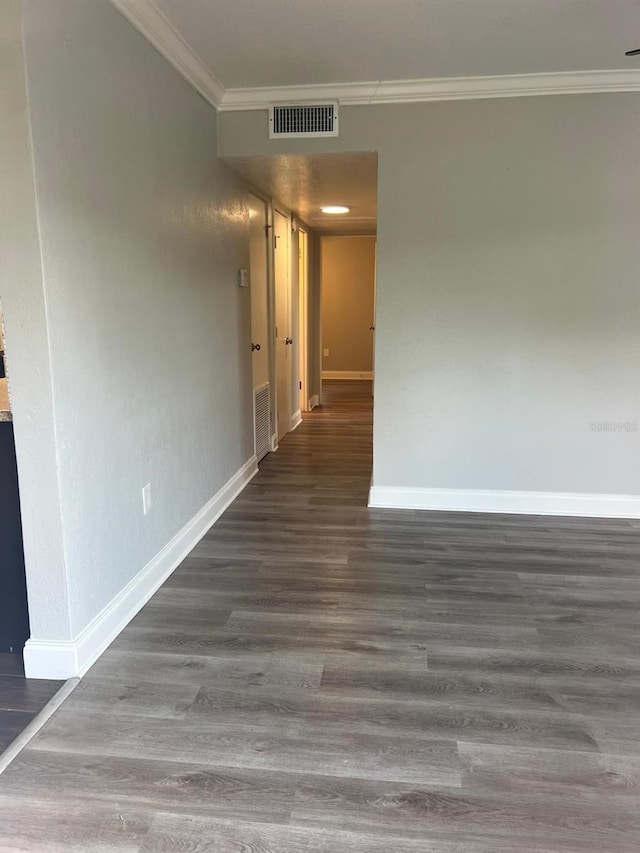 1315 Carlsbad Pl, Orlando, FL 32808 - empty room featuring crown molding and dark wood-type flooring