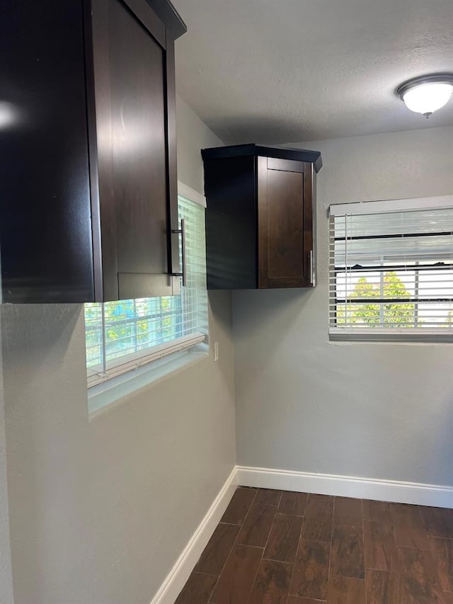 1315 Carlsbad Pl, Orlando, FL 32808 - interior space with dark brown cabinetry and dark hardwood / wood-style flooring
