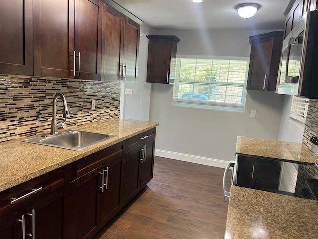 1315 Carlsbad Pl, Orlando, FL 32808 - kitchen featuring sink, dark wood-type flooring, stainless steel appliances, tasteful backsplash, and light stone countertops