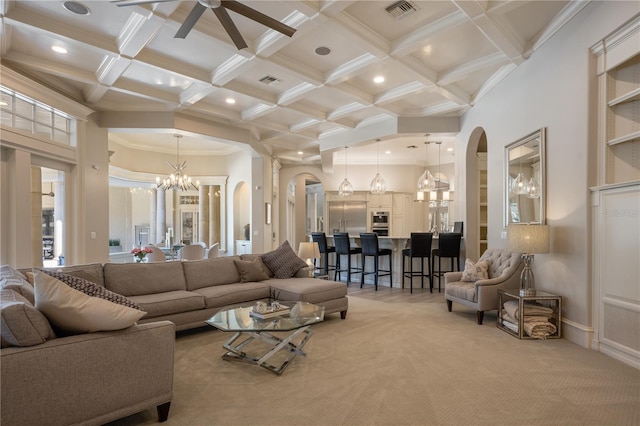 living room featuring coffered ceiling, crown molding, beamed ceiling, a towering ceiling, and carpet