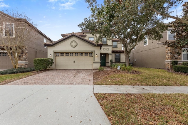 1494 Moon Valley Dr, Davenport, FL 33896 - view of front facade featuring decorative driveway, stucco siding, a garage, and a tiled roof