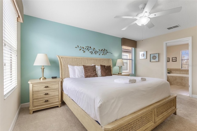 1494 Moon Valley Dr, Davenport, FL 33896 - bedroom featuring light carpet, ensuite bathroom, and ceiling fan