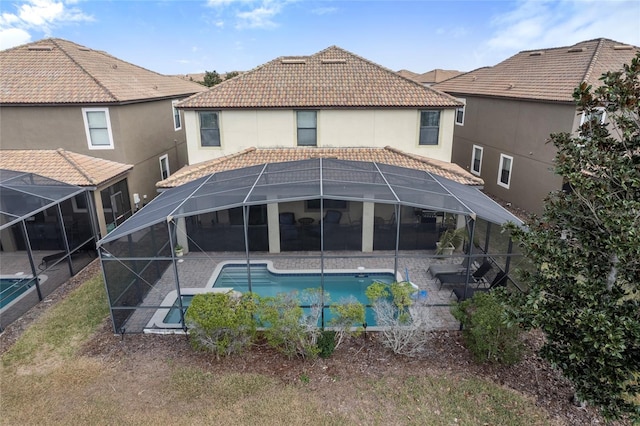 1494 Moon Valley Dr, Davenport, FL 33896 - rear view of property with a lanai, a patio, an outdoor pool, and a tiled roof