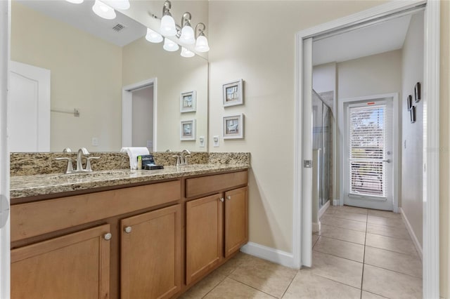 1494 Moon Valley Dr, Davenport, FL 33896 - bathroom with tile patterned floors, double vanity, and a shower stall
