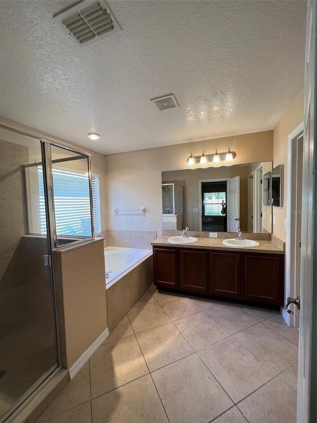 1515 Angler Ave, Kissimmee, FL 34746 - bathroom with tile patterned floors, vanity, independent shower and bath, and a textured ceiling