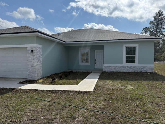 single story home with a garage and a front yard