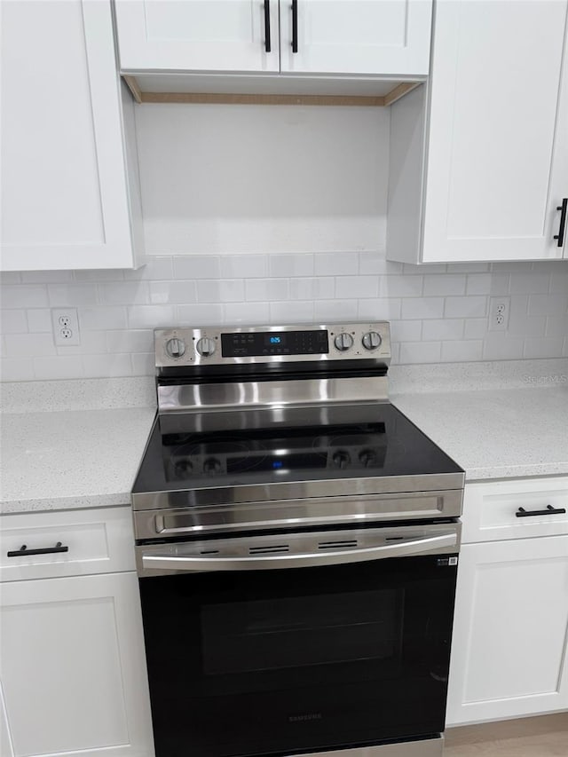 kitchen with white cabinetry and stainless steel range with electric cooktop