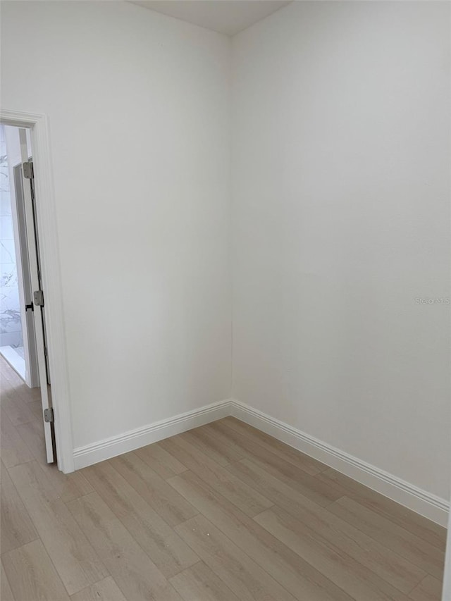 unfurnished room with light hardwood / wood-style floors