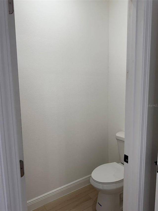 bathroom featuring toilet and hardwood / wood-style floors