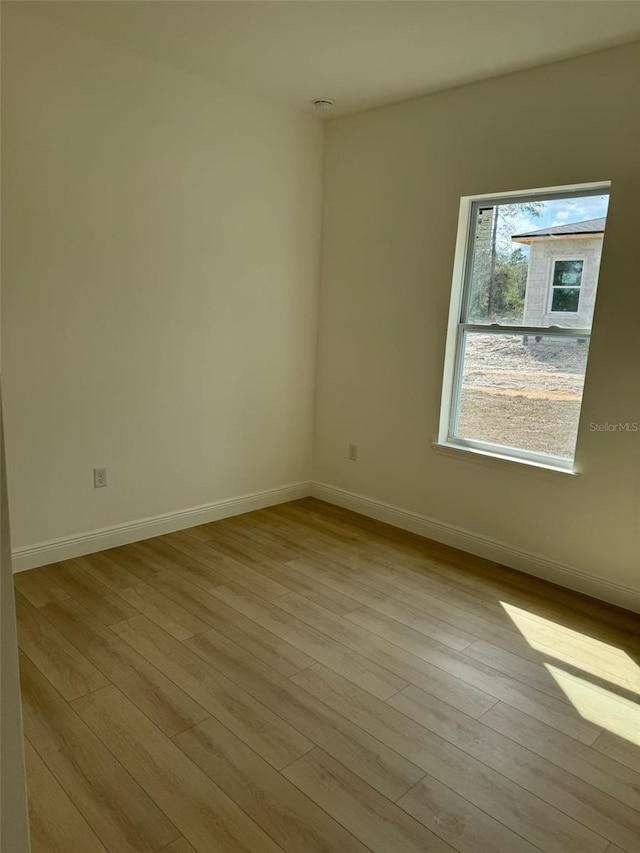 unfurnished room featuring light hardwood / wood-style flooring