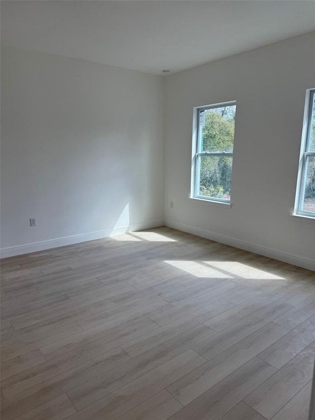 spare room with light hardwood / wood-style floors