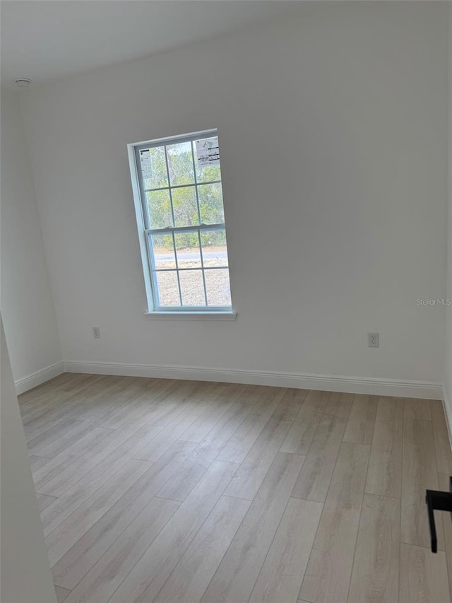 spare room featuring light hardwood / wood-style floors