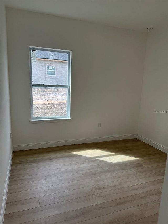 empty room with light hardwood / wood-style flooring