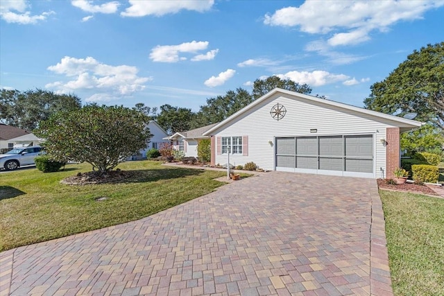 single story home featuring a garage and a front yard