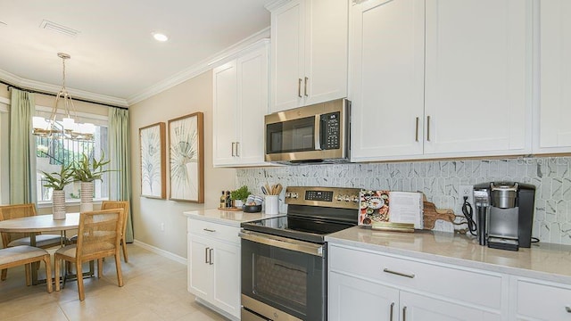 kitchen with white cabinetry, appliances with stainless steel finishes, crown molding, and decorative backsplash