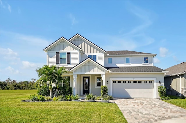 craftsman house featuring a garage and a front yard